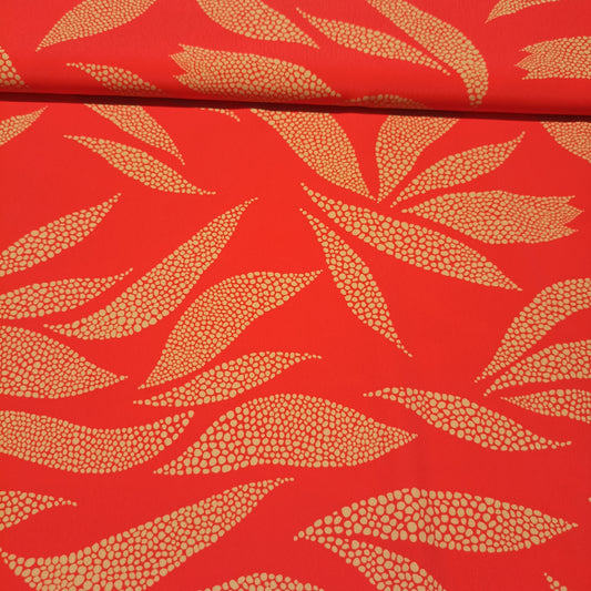 Polyester gouden stippen op koraalrode achtergrond